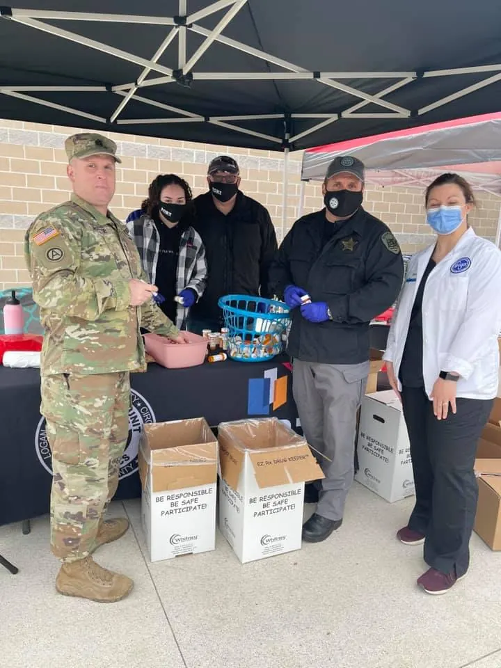 Major Crimes Unit, Project FORT and Ohio National Guard members at a drug take back table with boxes of collected medication